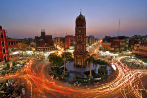 A clock tower at a busy crossing