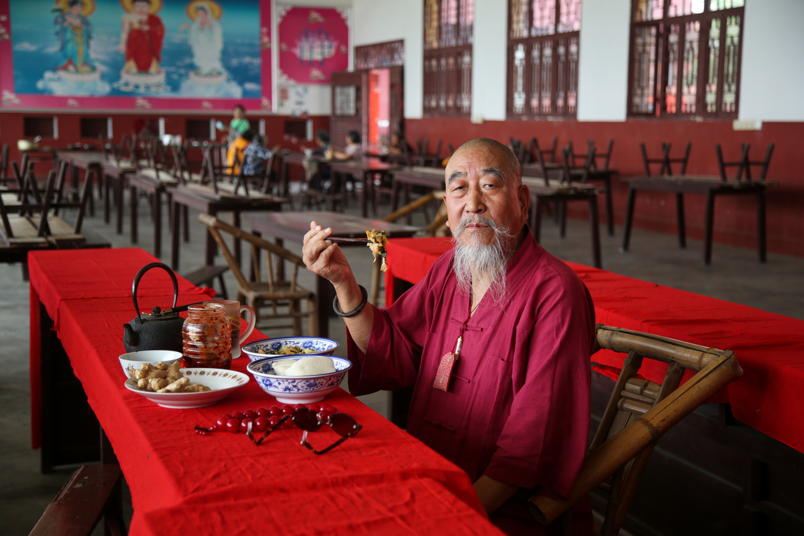 a person sitting at a table eating food
