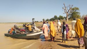 people waiting to board over crowded boat