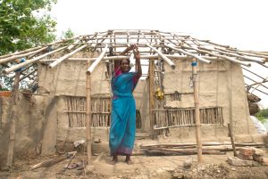 woman standing near incomplete house