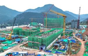 A construction site featuring multiple cranes and several buildings in various stages of development
